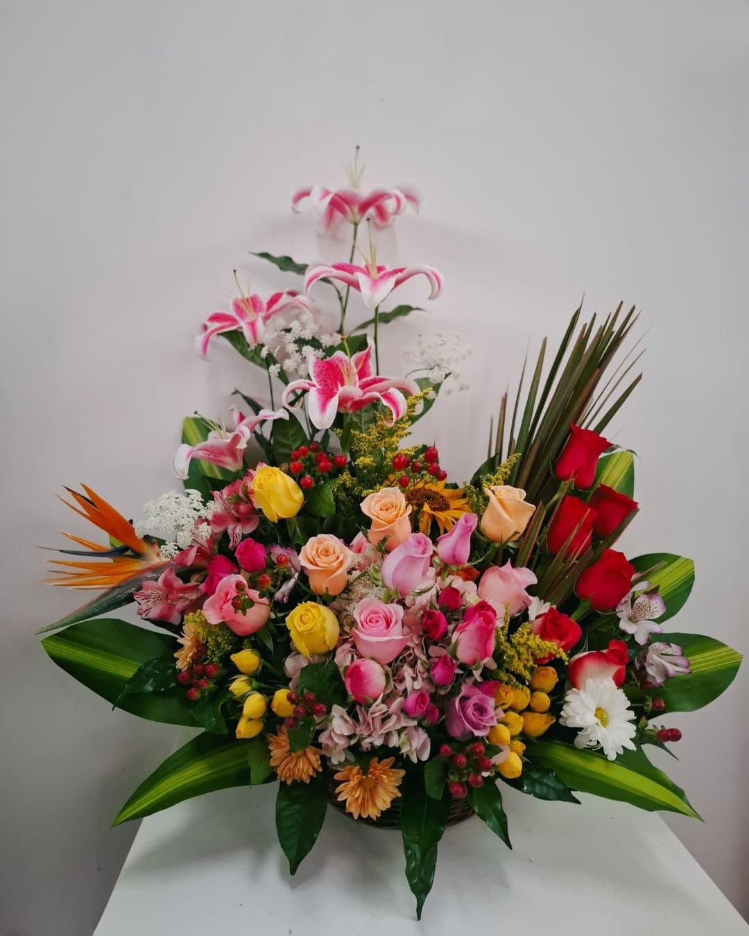 EUFORIA REAL – CANASTA DE LIRIOS ROSADOS CON ROSAS MIXTAS MINIRROSAS